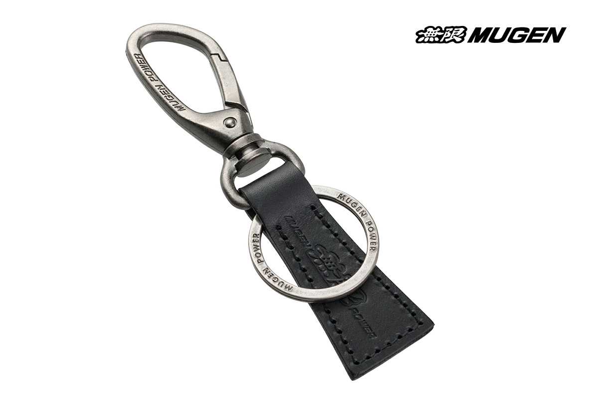 A close-up of the Mugen Power Key Holder A, showcasing its black Italian Buttero leather strap, silver zinc/nickel plated hook, and a double key ring, against a clean background.